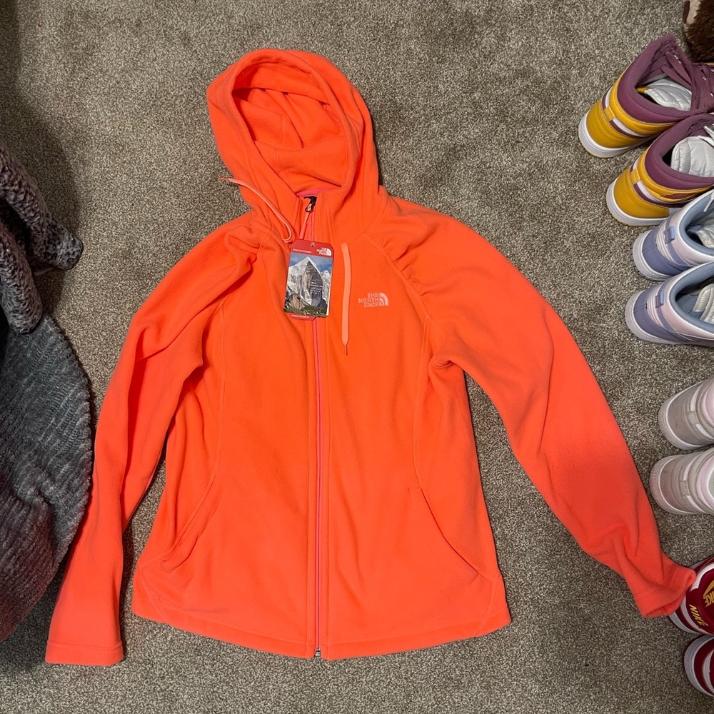 pinkish/orange north face zip up jacket
